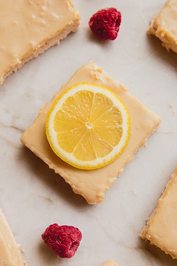 Lemon bar topped with a slice of lemon.
