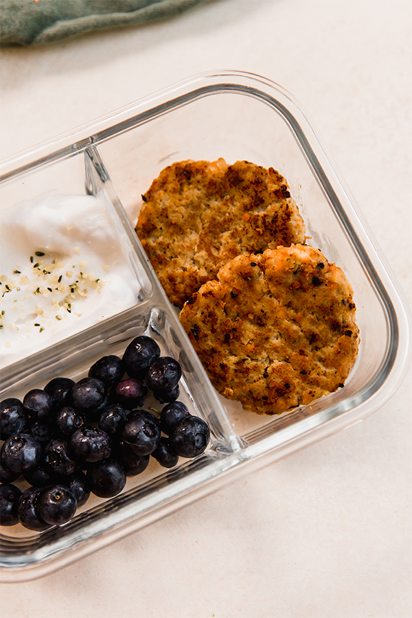 Food in a glass container with separated sections.