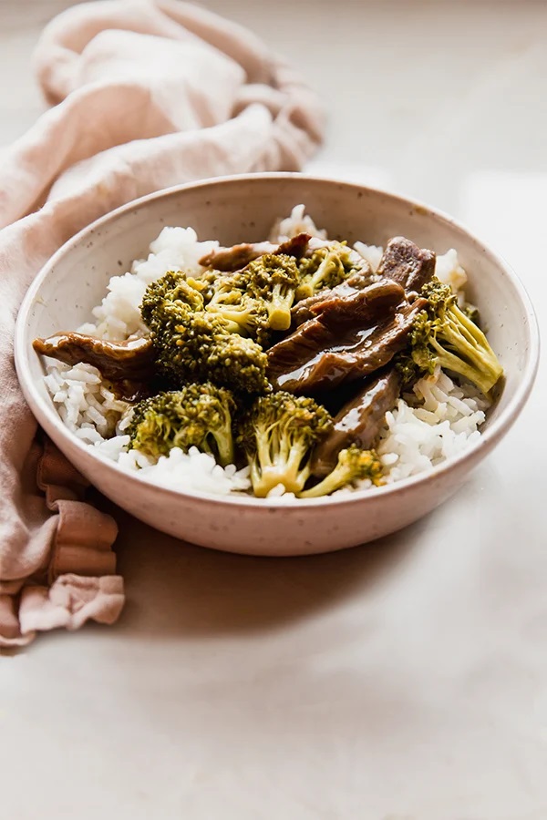 Orange beef and broccoli in a bowl with rice.