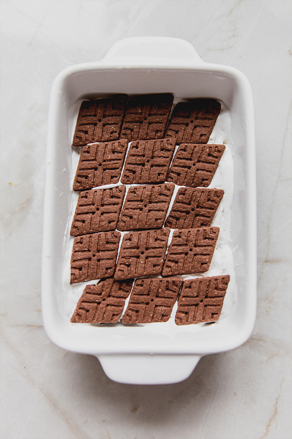 A dish with the first layer of the ice box cake layered in.