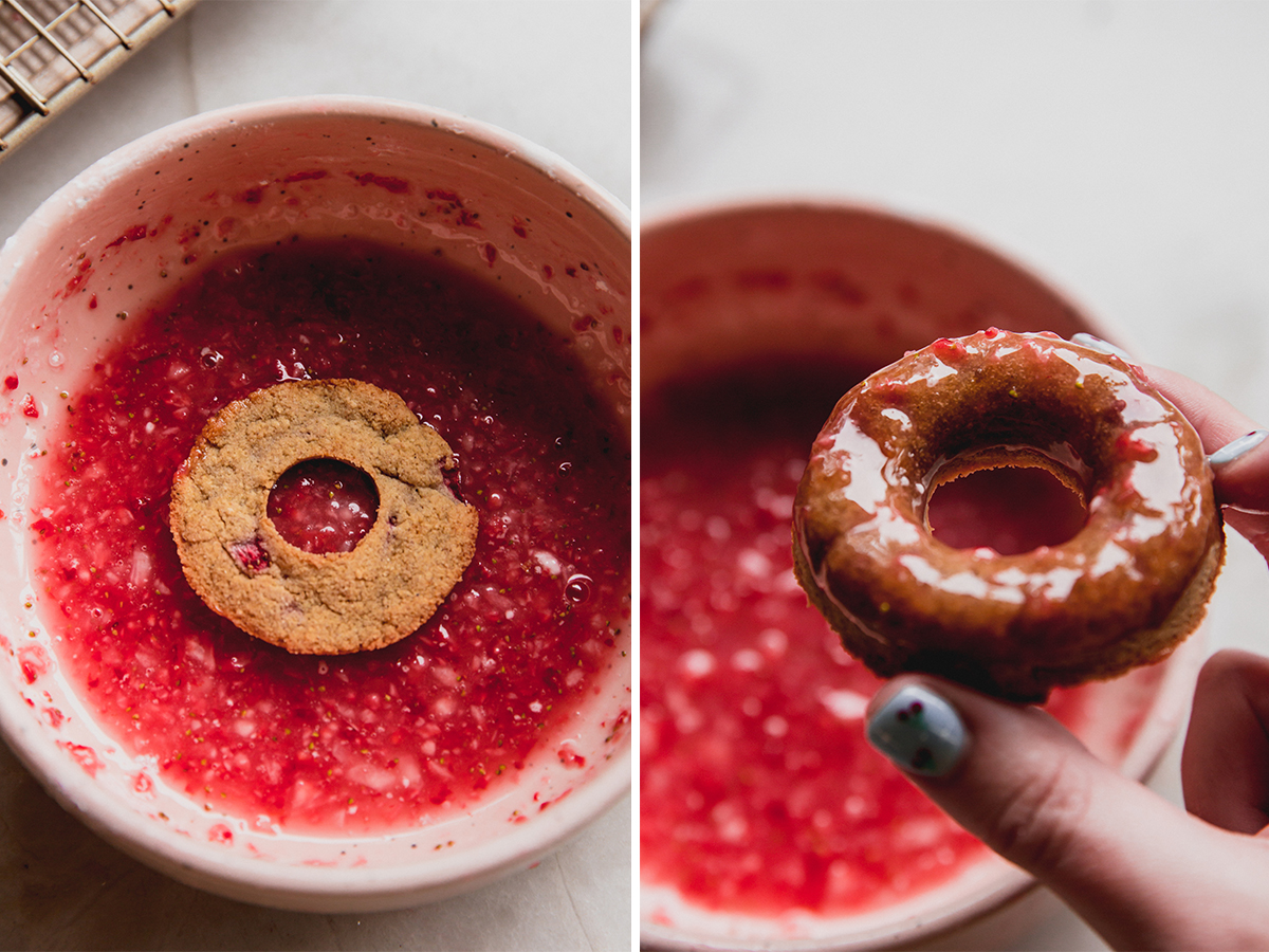 The strawberry mini donuts being dipped into the strawberry glaze.