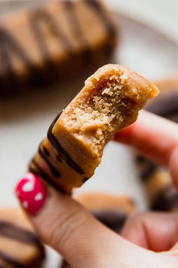 A cookie dough protein bar with a bite taken out of it.