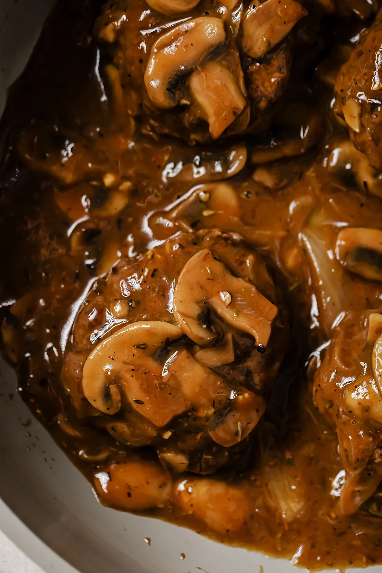 Hamburger steak topped with mushrooms and gravy.