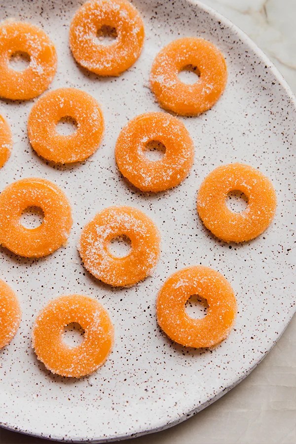 Plate with several peach ring gummies.