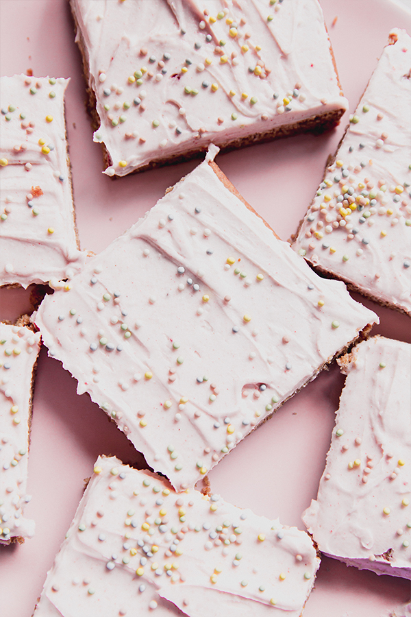 Funfetti pink sugar cookie bars on a pink plate.