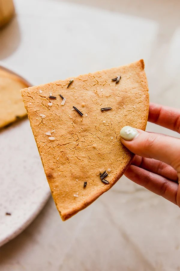 Person holding a slice of socca.