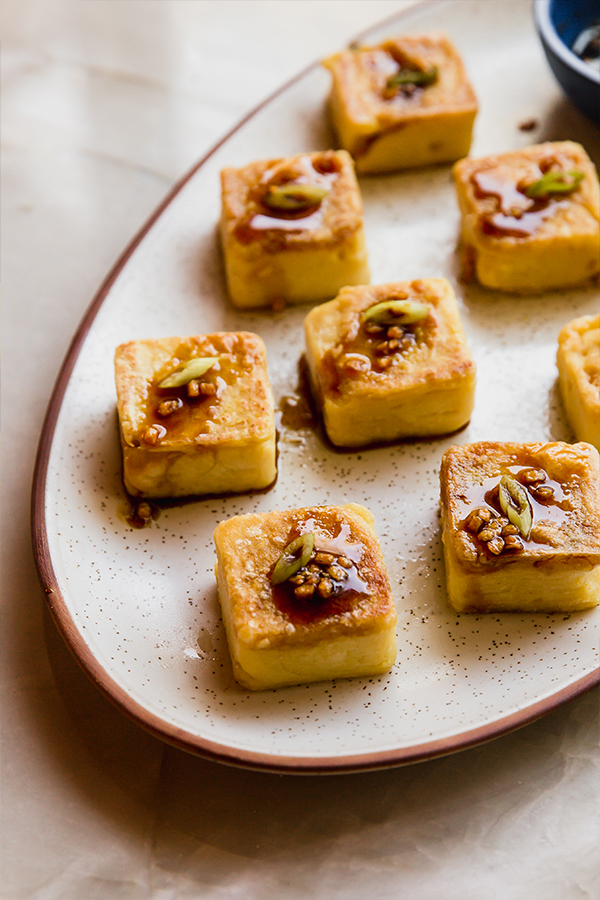 Chickpea tofu topped with a honey garlic sauce.