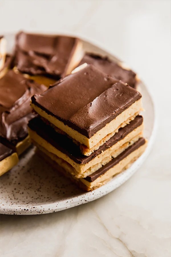 Pumpkin spice s\'mores bars stacked on a plate.