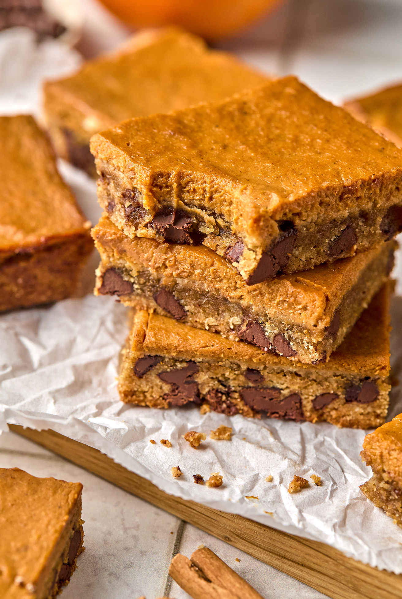 Three pumpkin chocolate cookies bars stacked on top of each other.