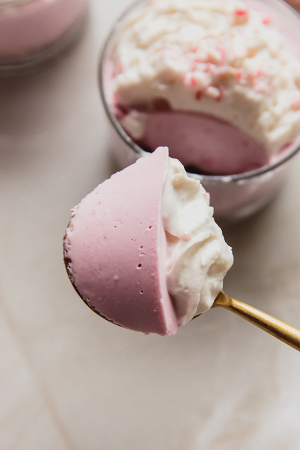 A spoon with a bite of mini peppermint pie cups on it.