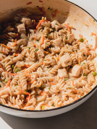 Chicken pot pasta in a large white cast iron pan.