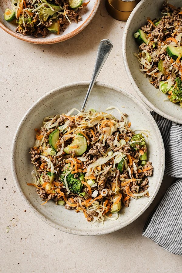 Plate of ground beef stir fry with a fork.