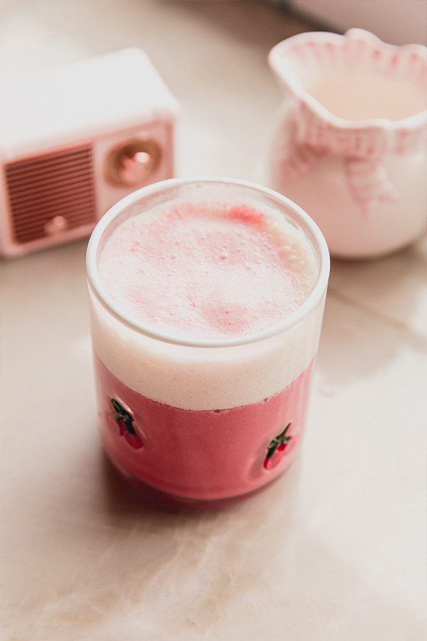 Small glass of pink beet latte.