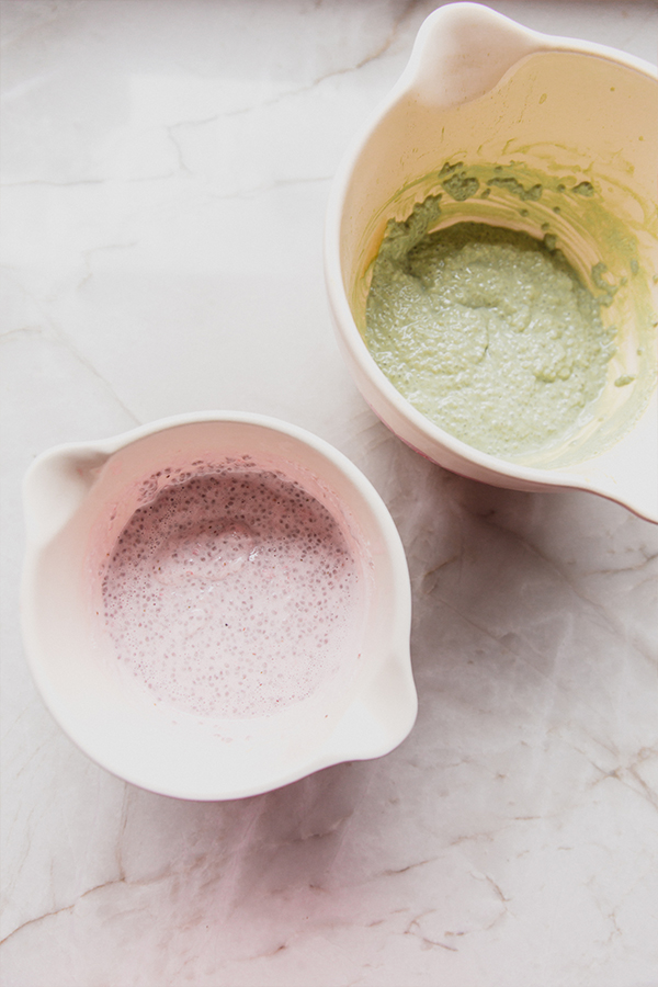 Two bowls of strawberry and matcha chia pudding before layering them.