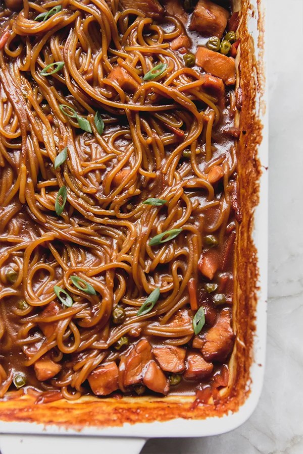 Baking dish of honey garlic chicken noodles.