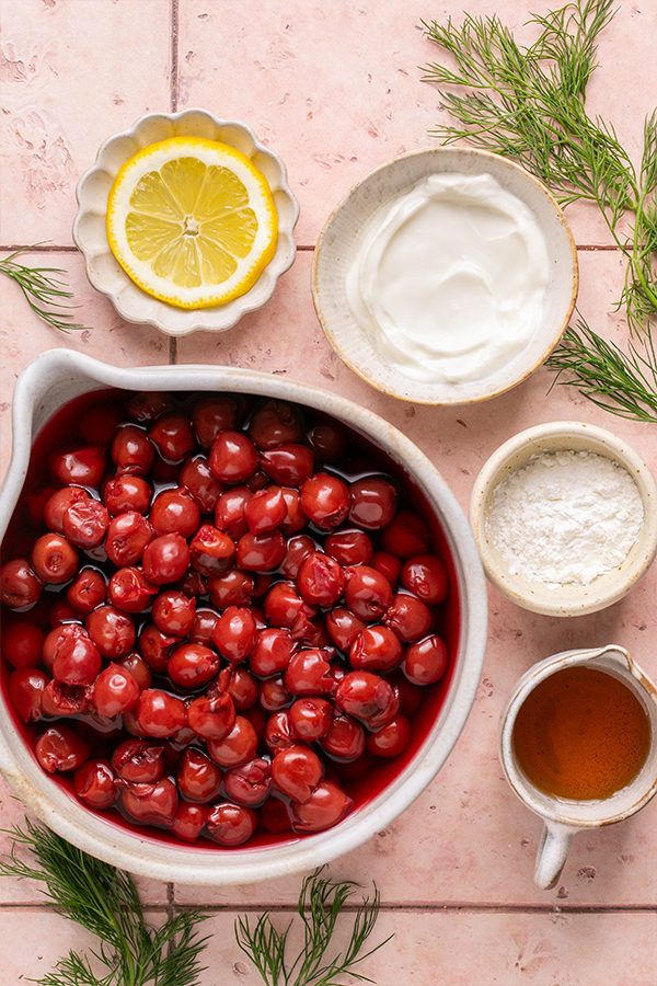 Ingredients including maple syrup, coconut yogurt, and a lemon slice.