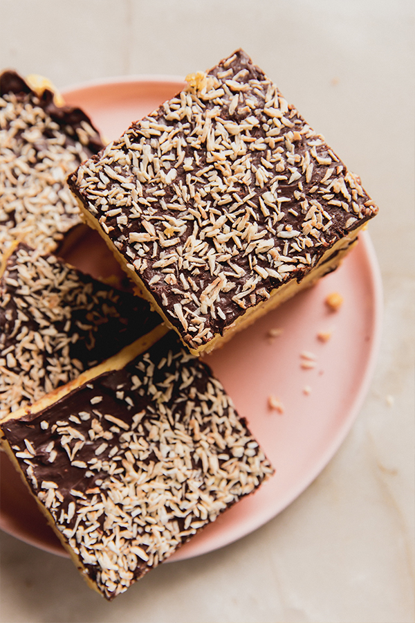 A plate of lemon coconut s'mores bars stacked ready to be enjoyed.