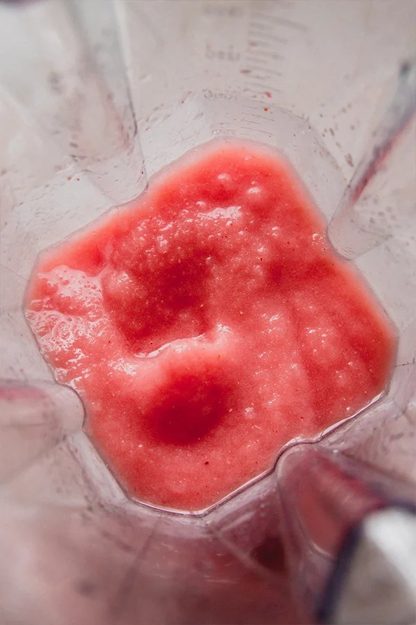 Frozen watermelon margarita mocktail blended in a blender.