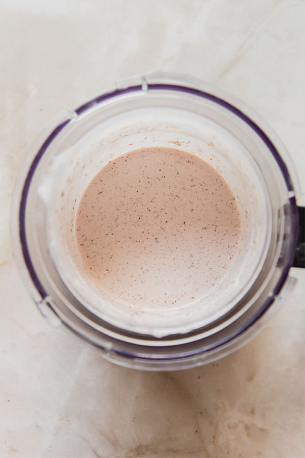 Almond milk, dairy free ice cream and gluten free cookies fully blended in a ninja creami cup.