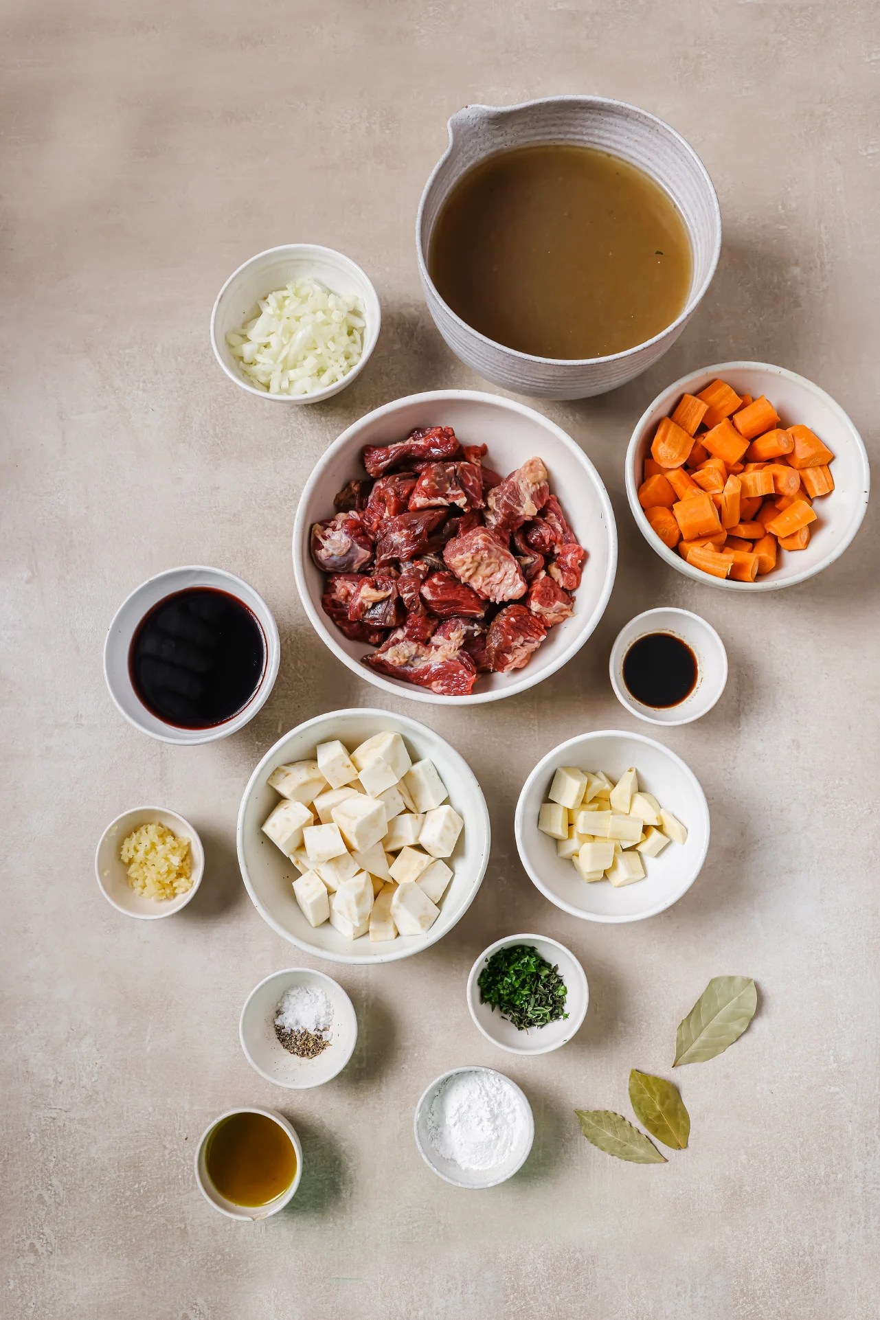 Dutch oven beef stew ingredients in seperate bowls.