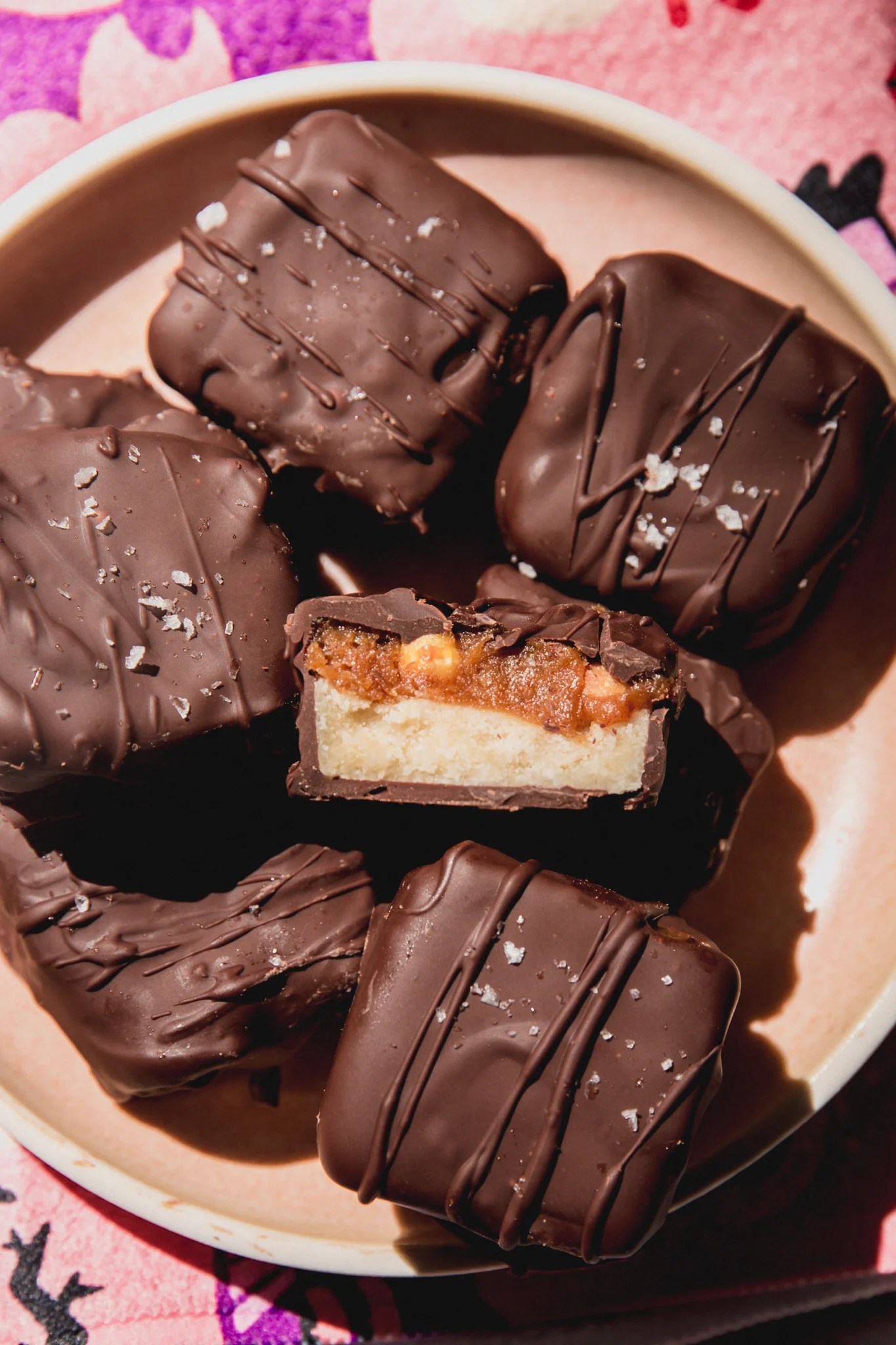 Mini snickers bars on a plate, with one cut in half.