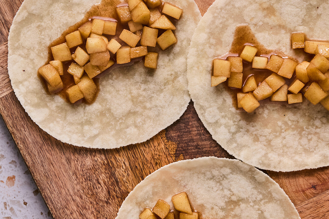 Gluten free tortillas topped with cooked apples.