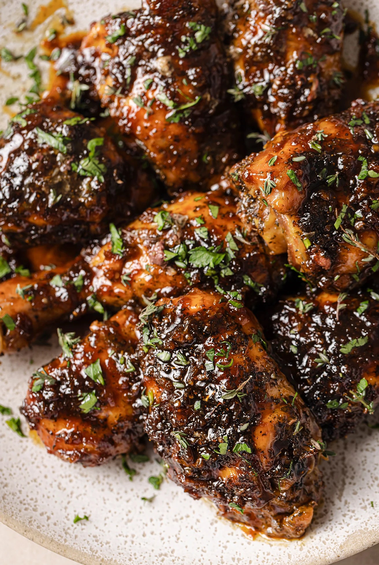 Turkey wings on a platter topped with chopped parsley.