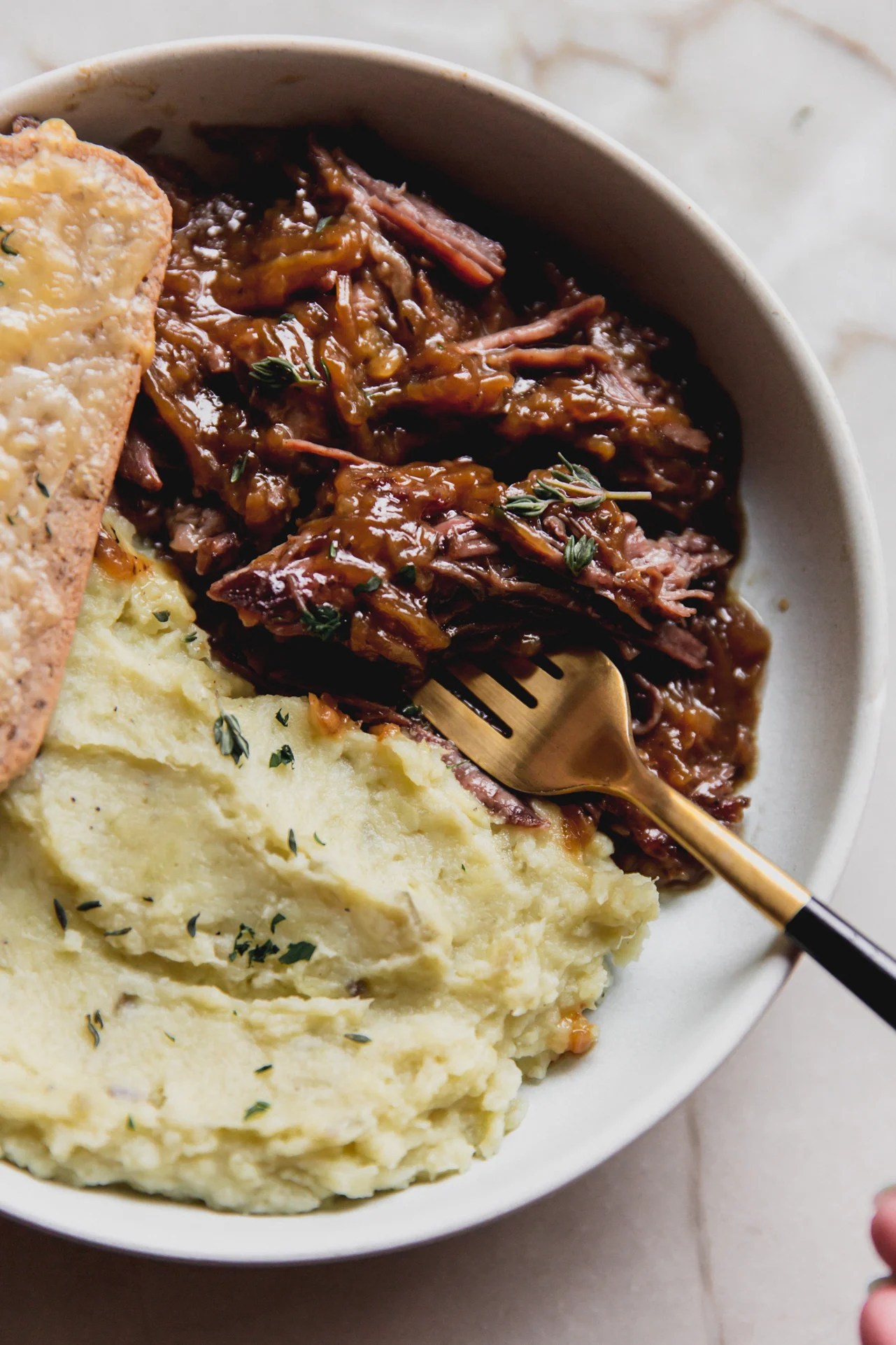 French onion pot roast with a side of mashed sweet potato and cheese toast.