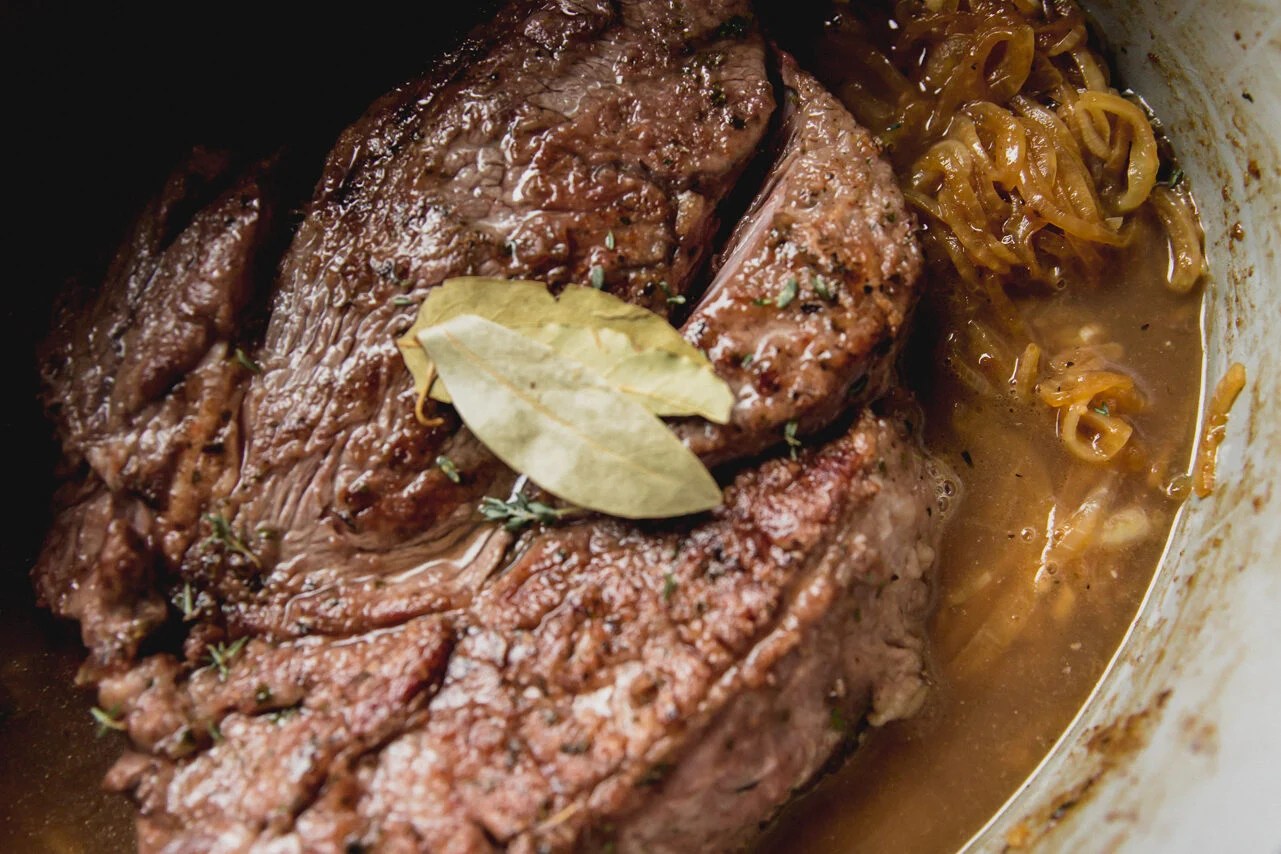 The pot roast in the Dutch oven before going in the oven.
