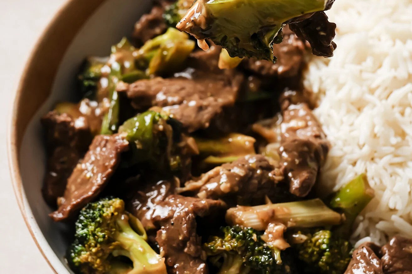 Gluten free mongolian beef on a plate with a fork.