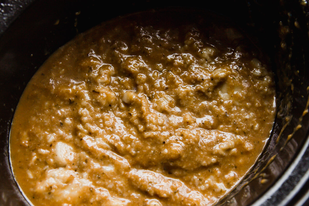 Slow cooker chicken pasta covered with sauce.