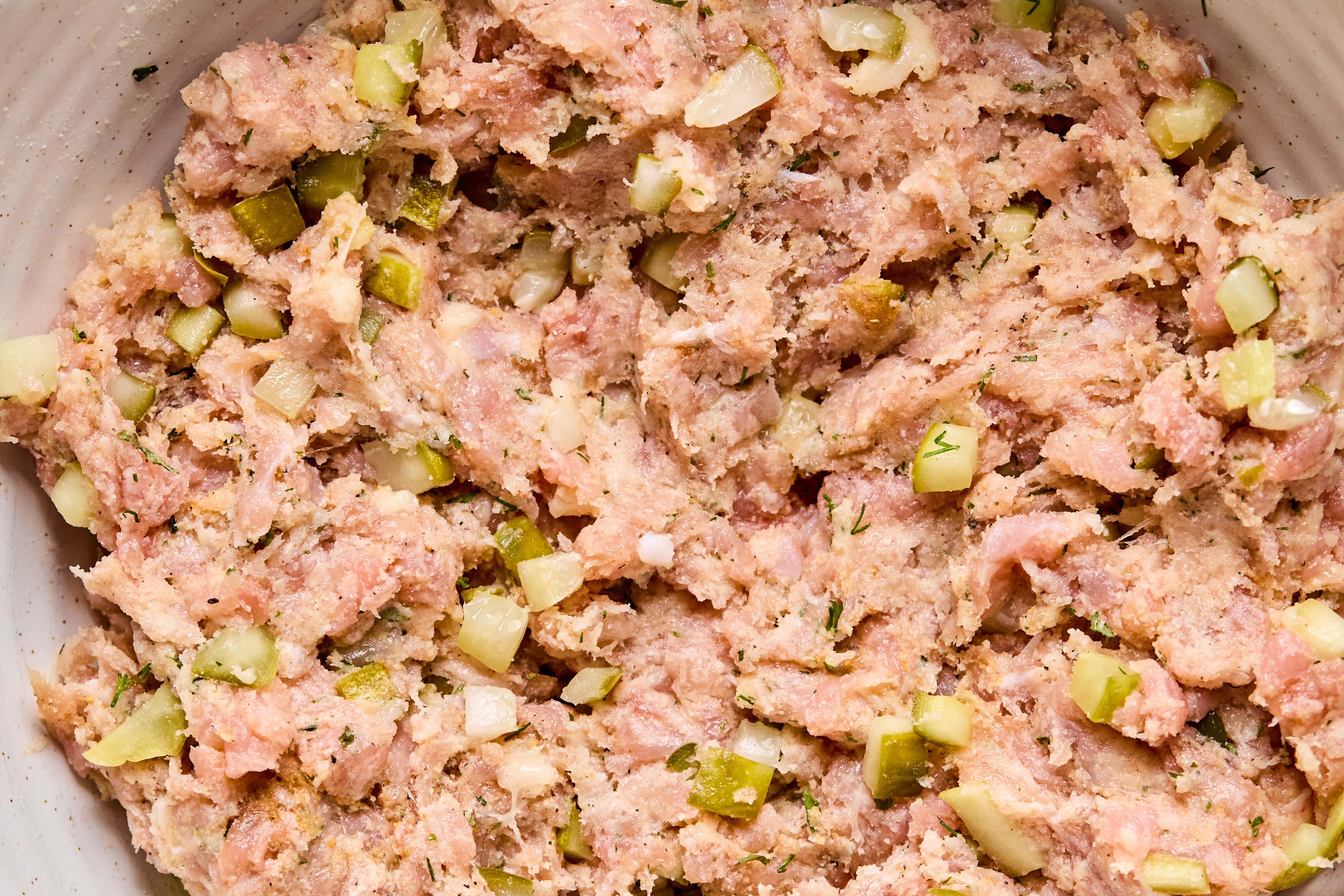 Ground chicken, seasonings, dill and chopped pickles all mixed well in a bowl