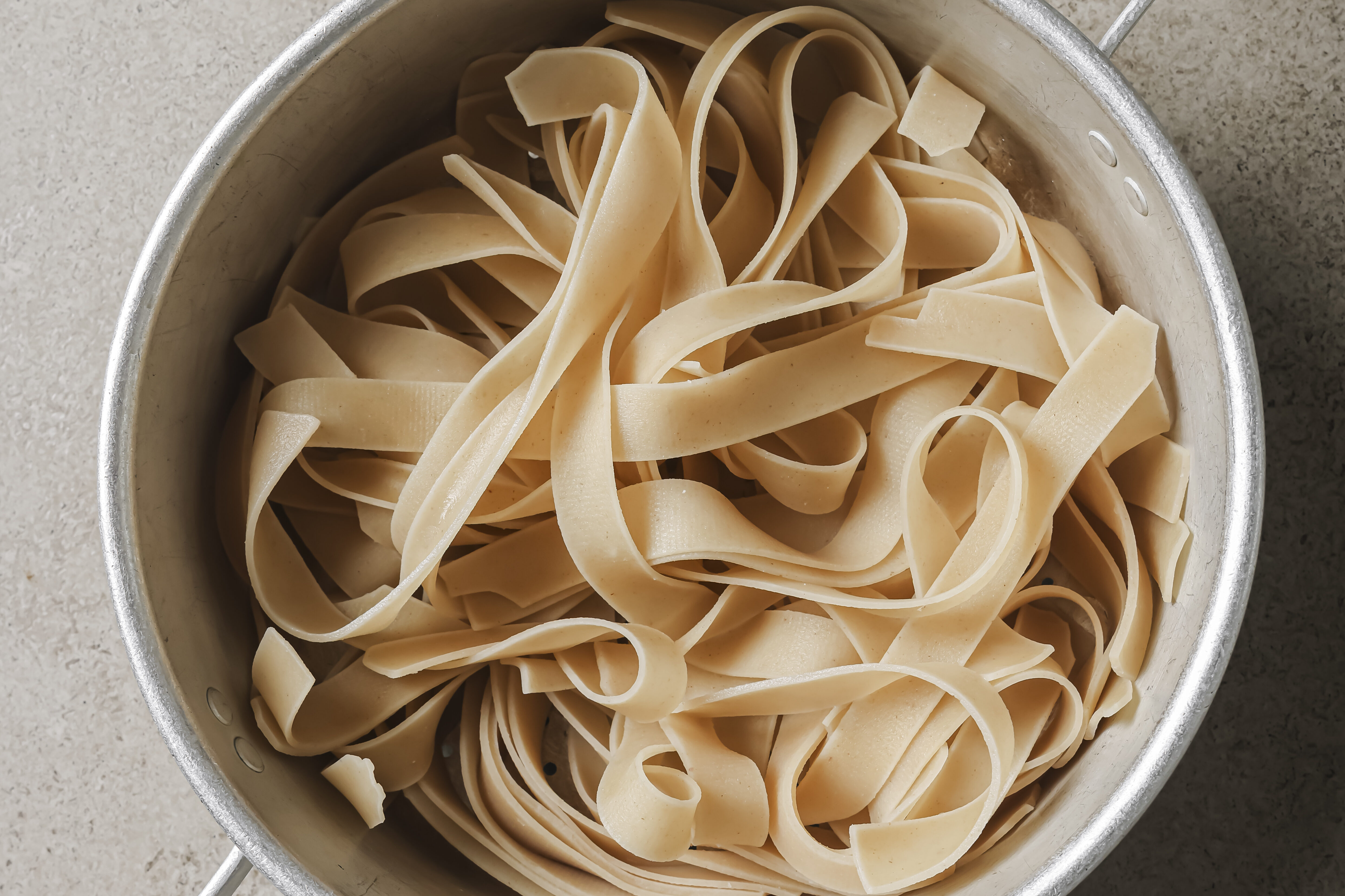 Fully cooked rice noodles in a pot.