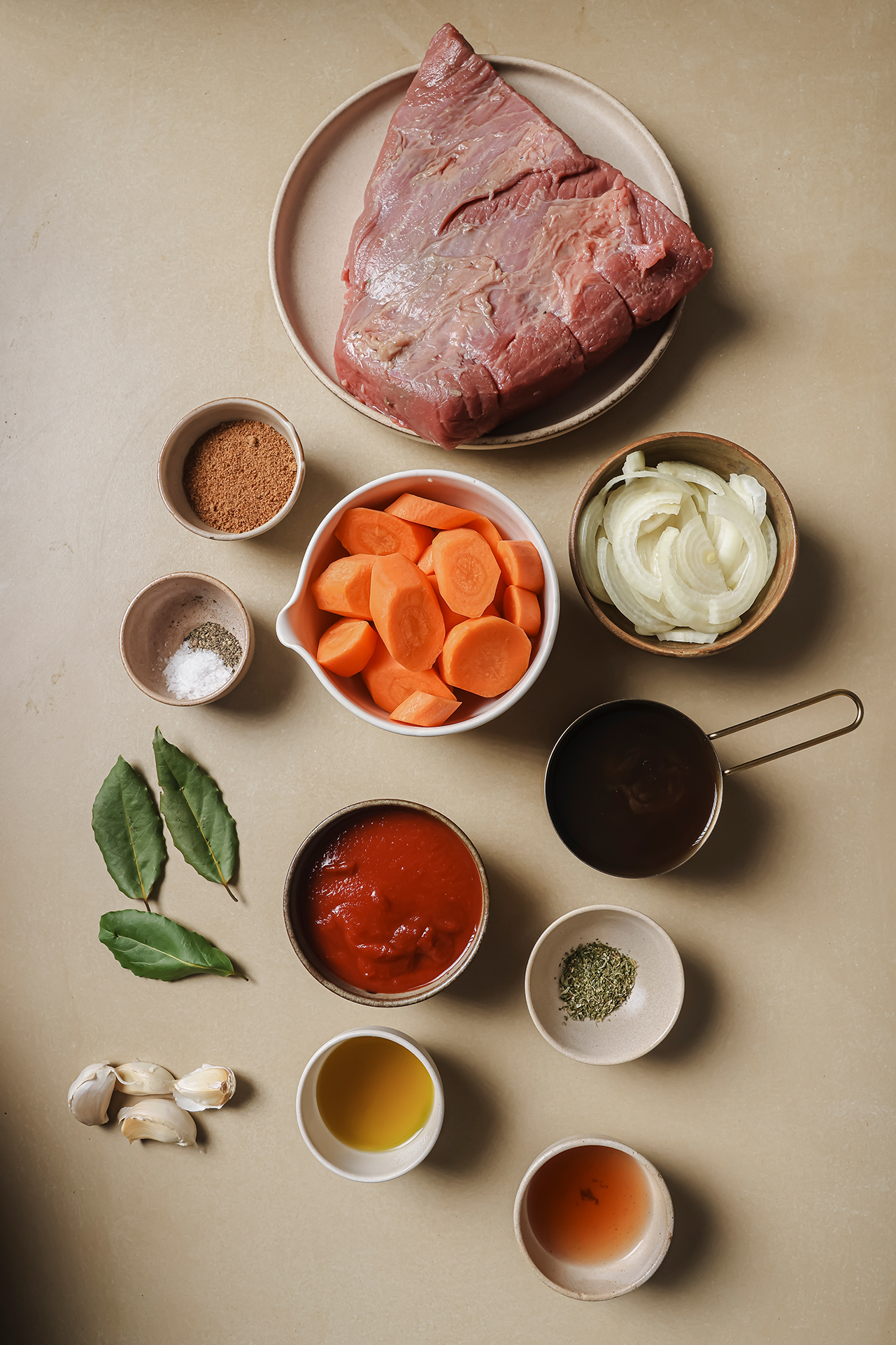 All the ingredients needed to make Passover brisket laid out on a counter.