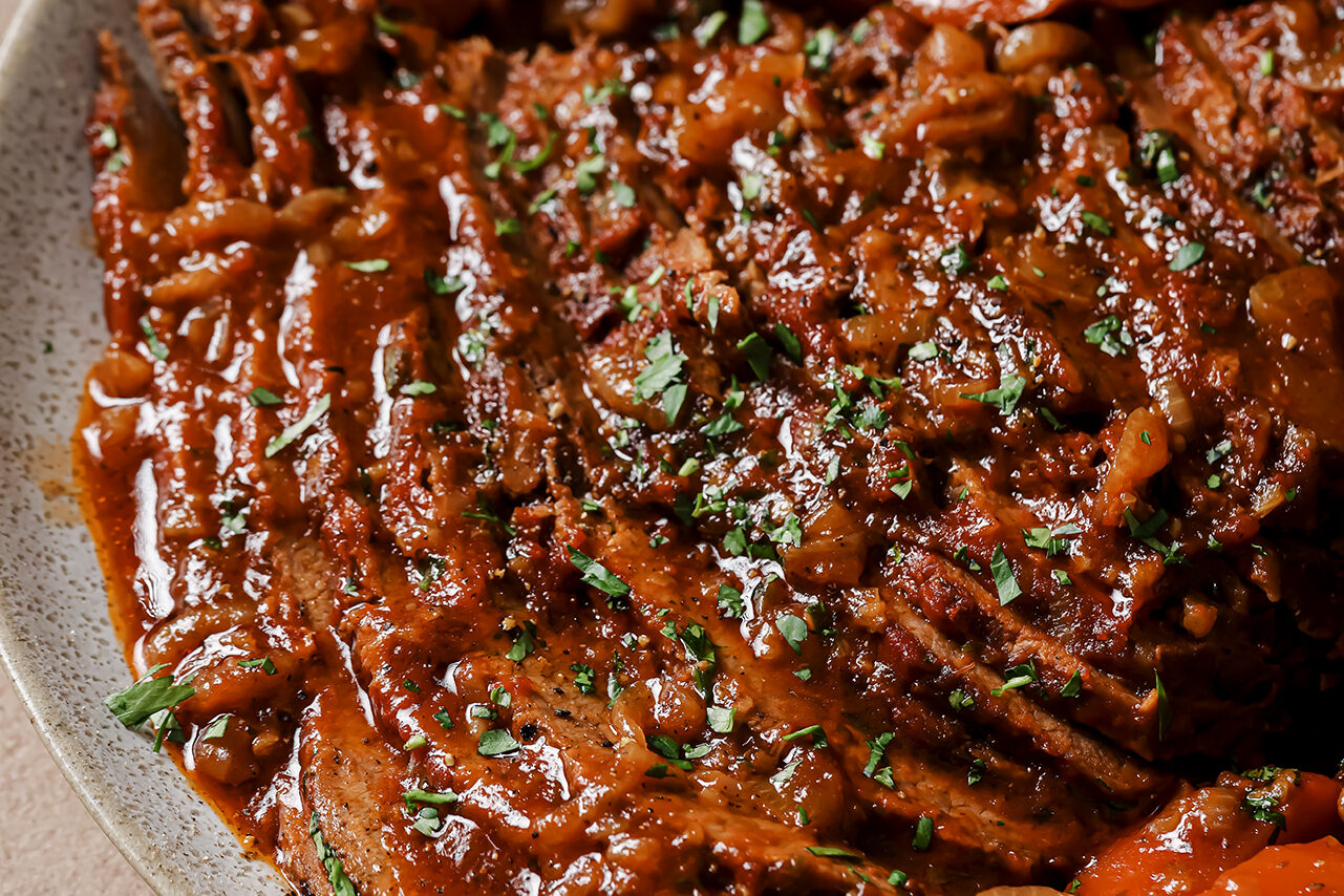 The brisket sliced and on a plate read to be eaten.
