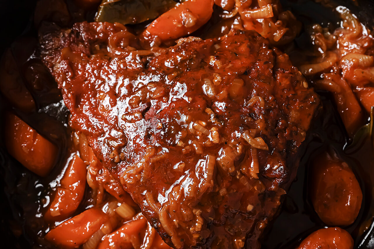 The brisket after baking in the cast iron skillet.