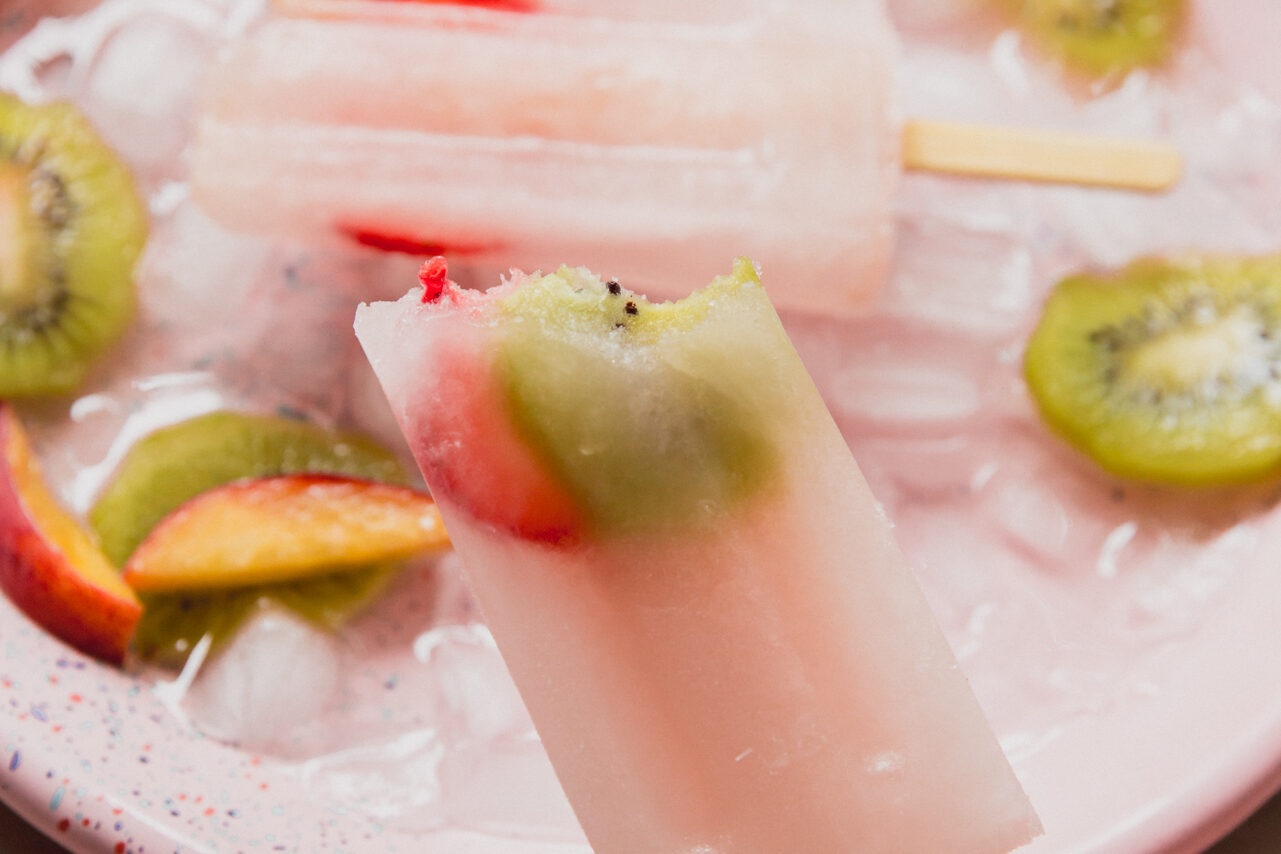 A popsicle after being frozen with a bite taken out of it.