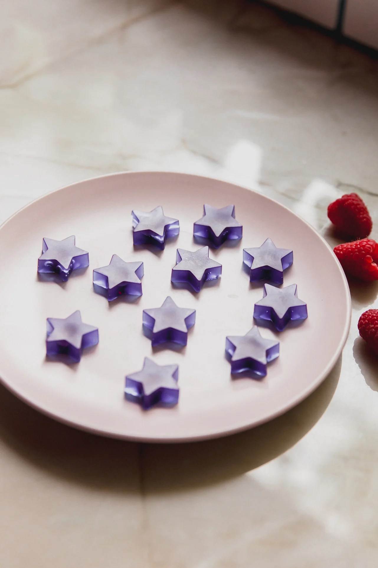 A white plate with blue raspberry gushers sitting on it.