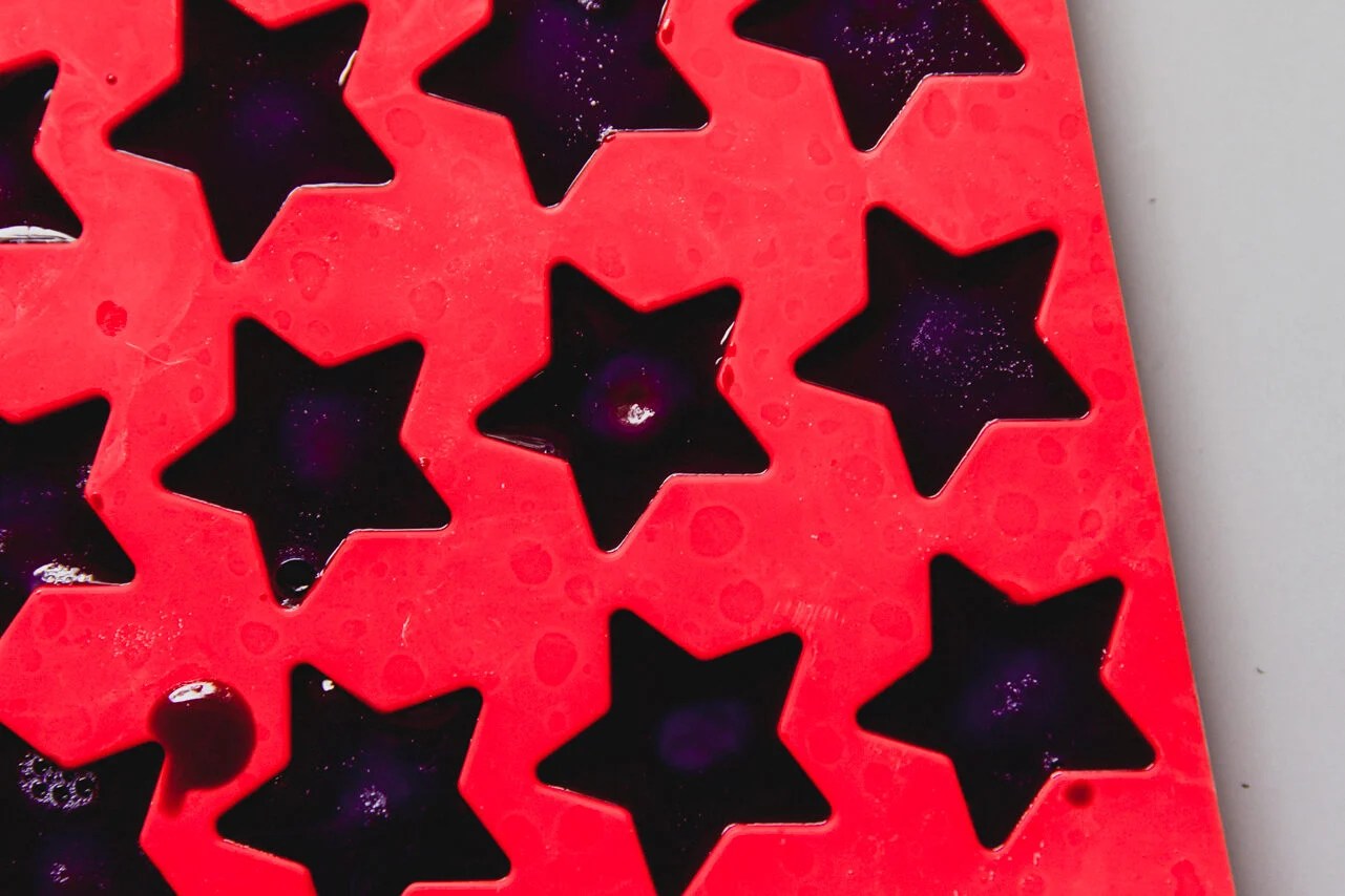 A red mold with the gushers set in it before being removed.