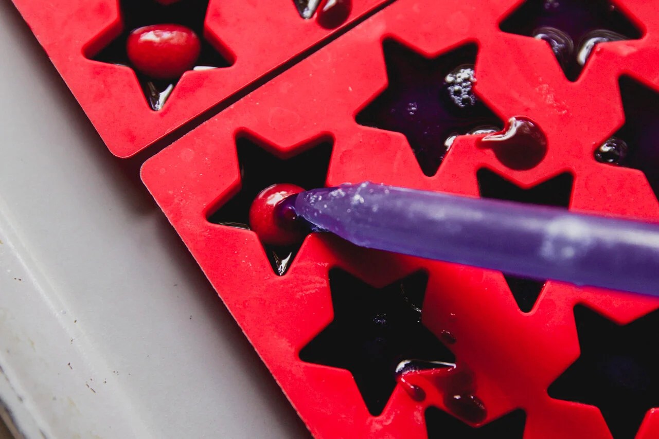 A dropper putting a drop into the mold.