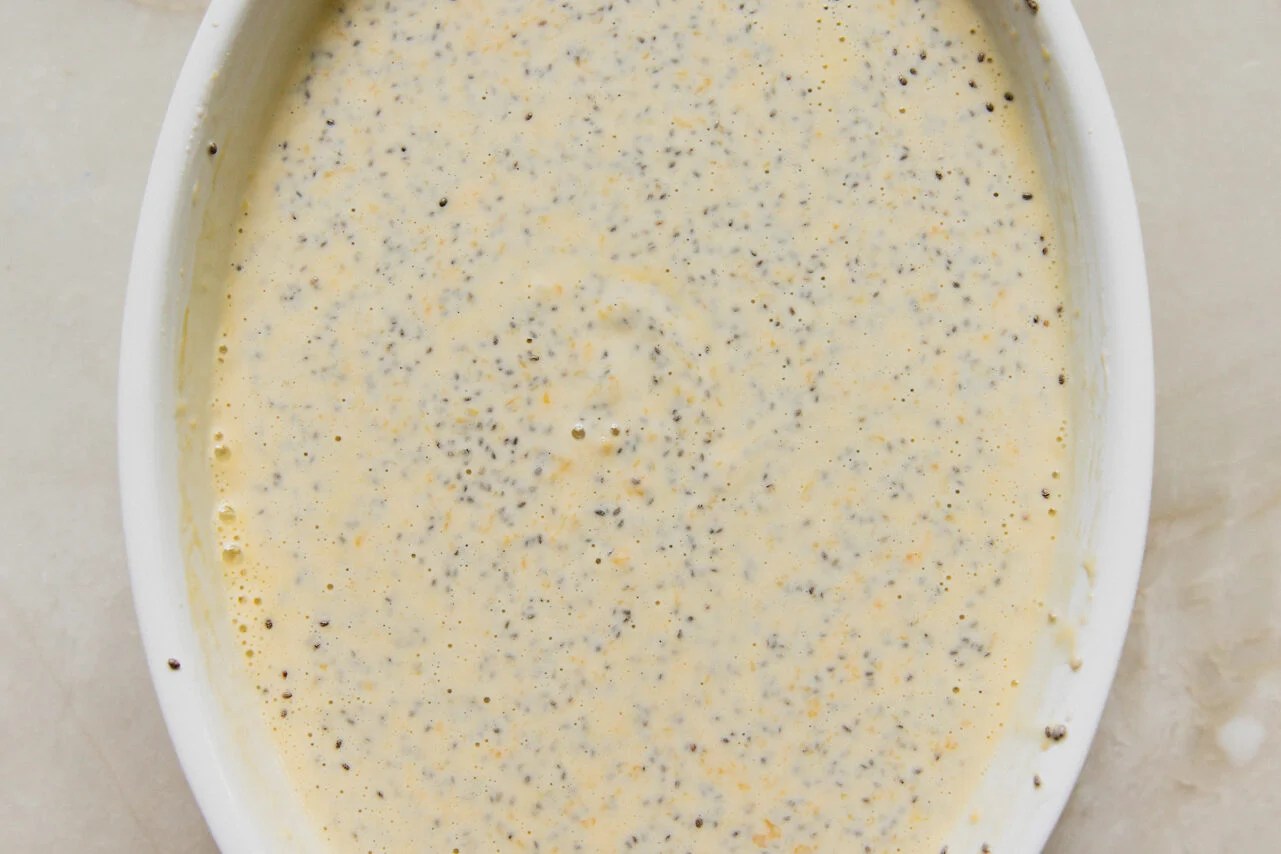 Mango chia pudding ingredients in a baking dish before setting