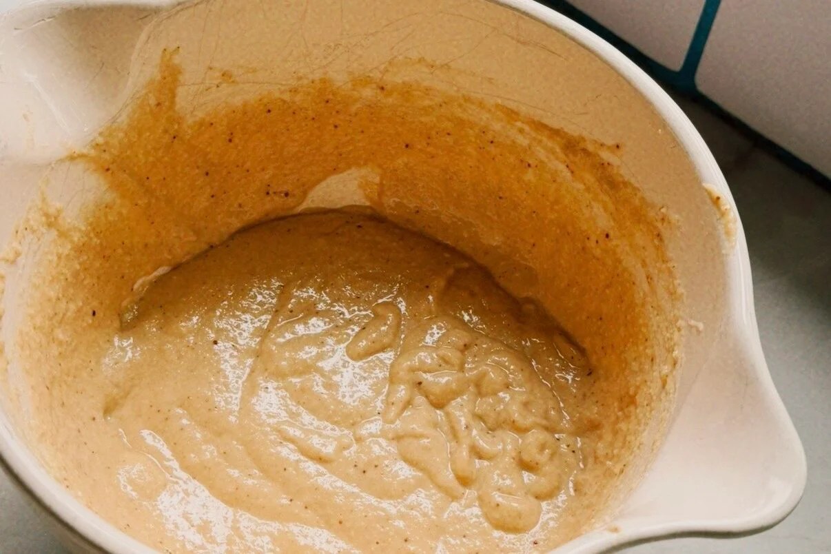 A white ceramic bowl filled with pancake batter.