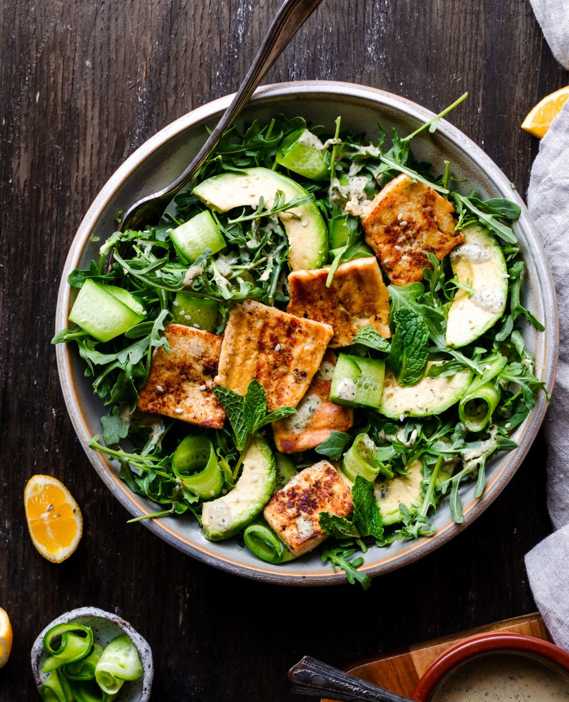 The most refreshing vegan tofu halloumi and cucumber salad! With arugula, cucumber, and a mint tahini dressing. So flavorful and refreshing!