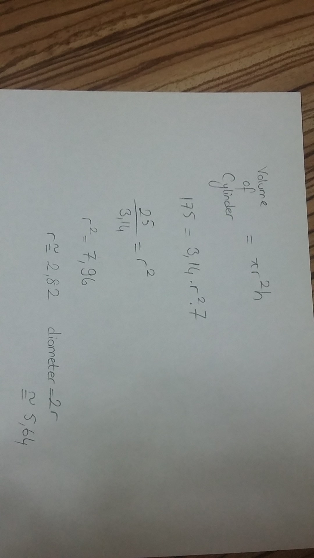 A cylinder has a volume of 175 cubic units and a height of 7 units. The