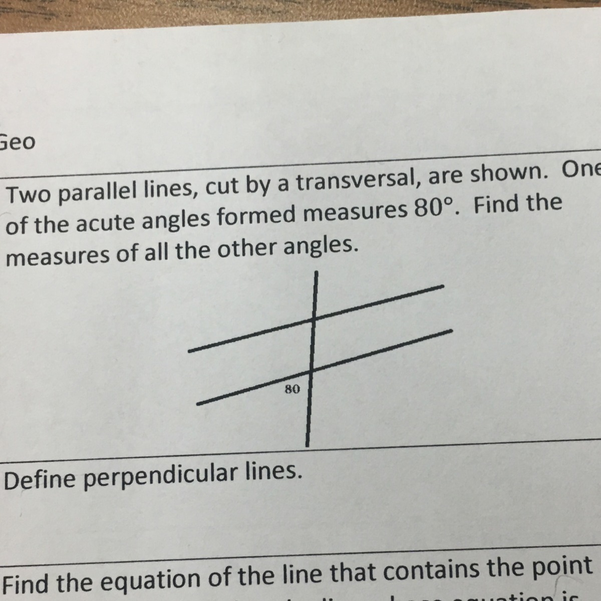 Two parallel lines, cut by transversal, are shown. One of the acute