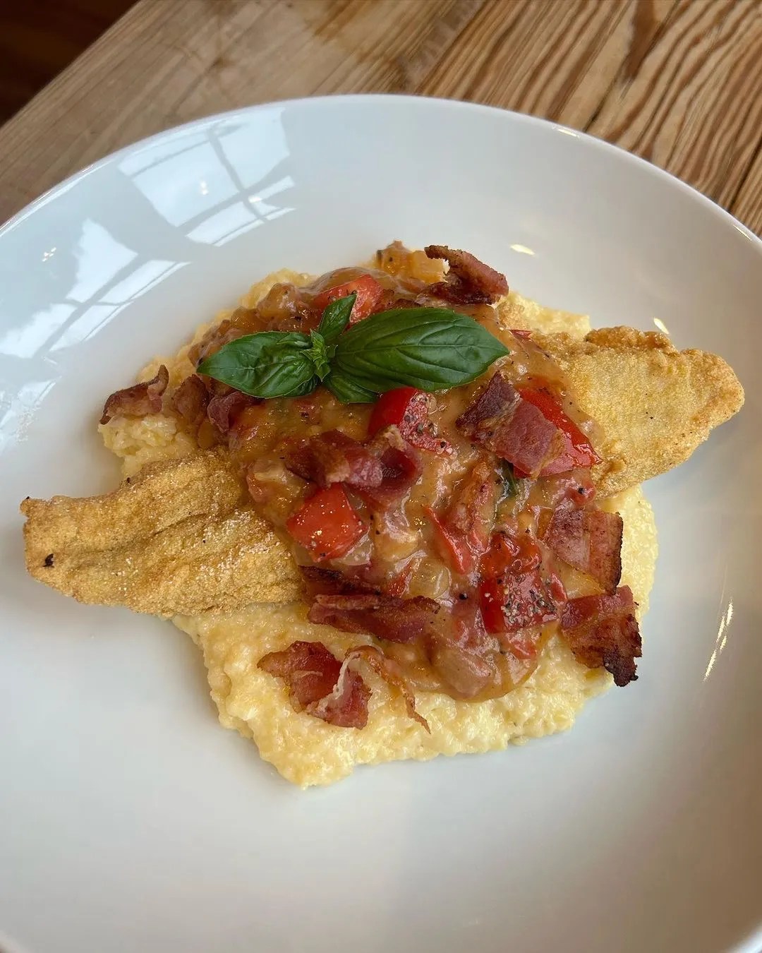 Crispy Fried Catfish atop Creamy Grits and Bacon Tomato Gravy TCI