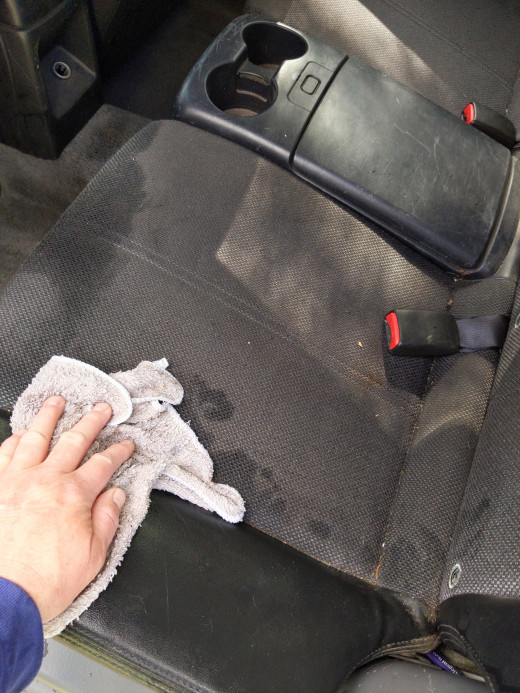 Car Interior Cleaning With a Bucket of Soapy Disinfectant Solution