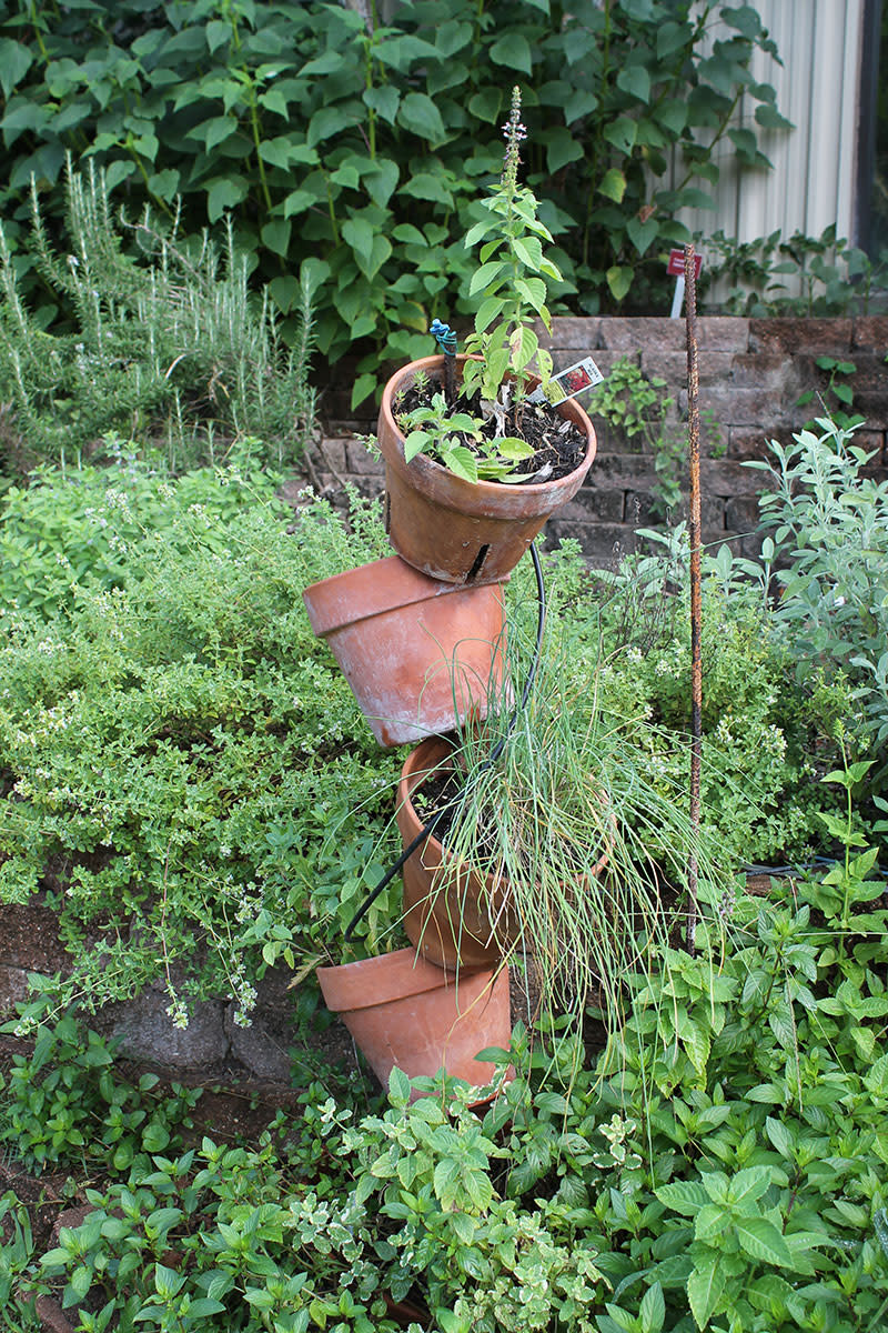 Wacky Creative Garden Art Blending junk and vintage items into