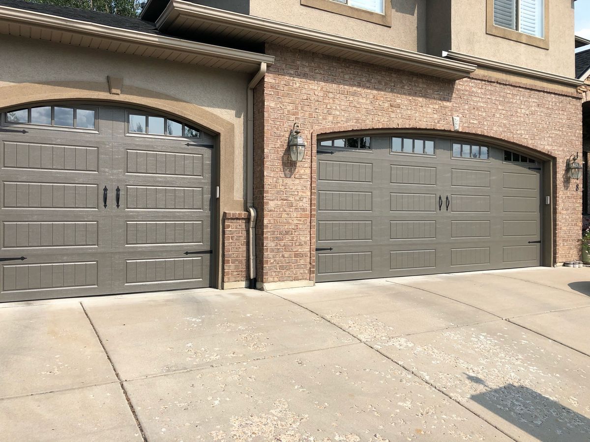 Long Bead Board Garage Door With Windows and Decorative Hardware in