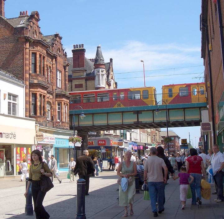 Metro train passing between Victorian buildings in South Shields